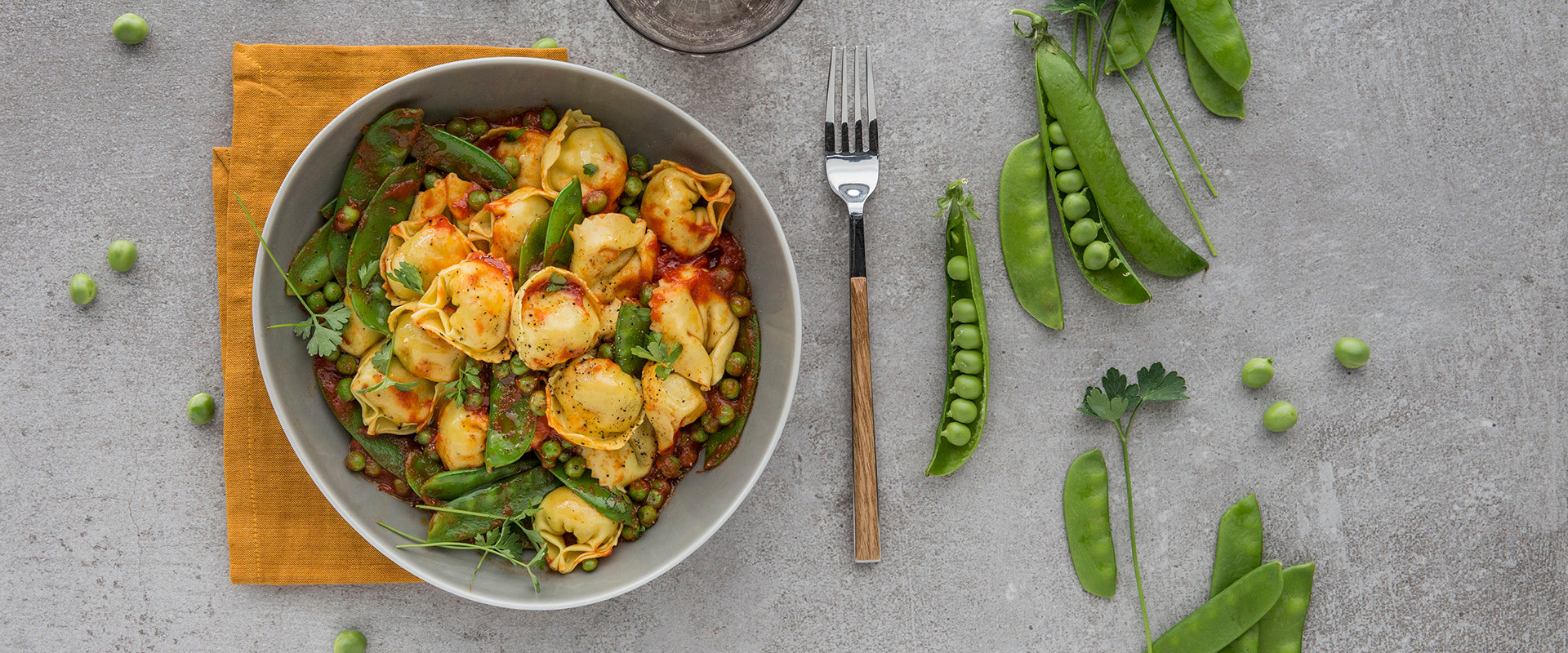 Chicken & Smoked Pancetta Tortelloni with snow peas, peas and tomato
